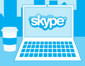Skype logo on laptop with coffee