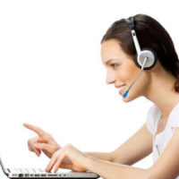 Woman with headset at laptop