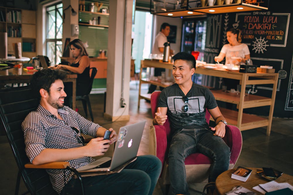 Two men talk in a work environment