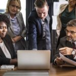 business people looking at a laptop